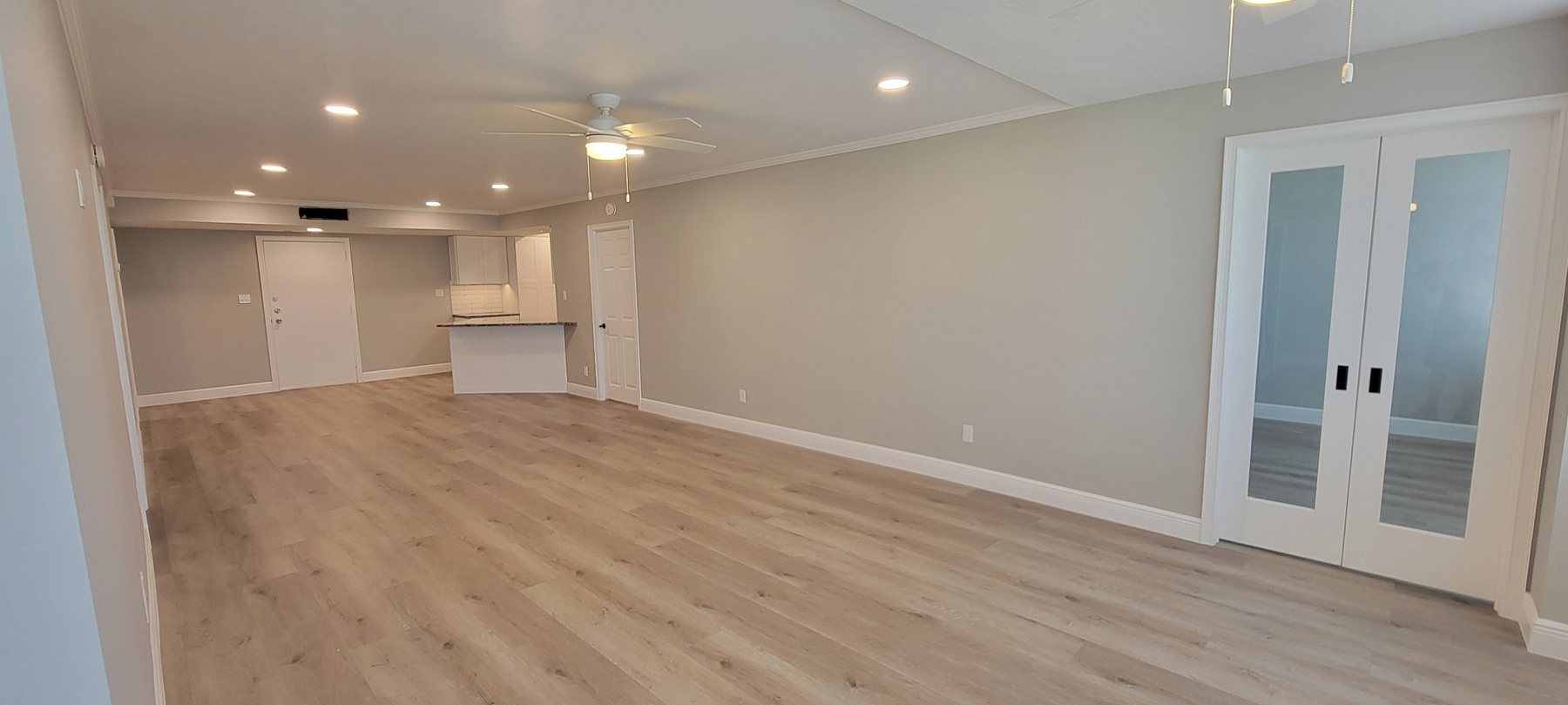 Completed open living room with new flooring and doors