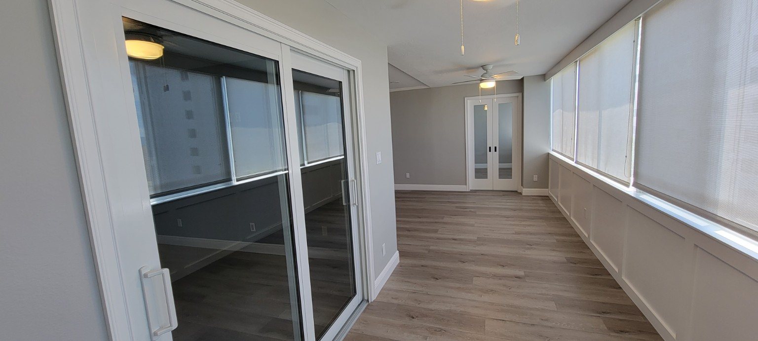 Completed enclosed waterfront room with new flooring trim and doors