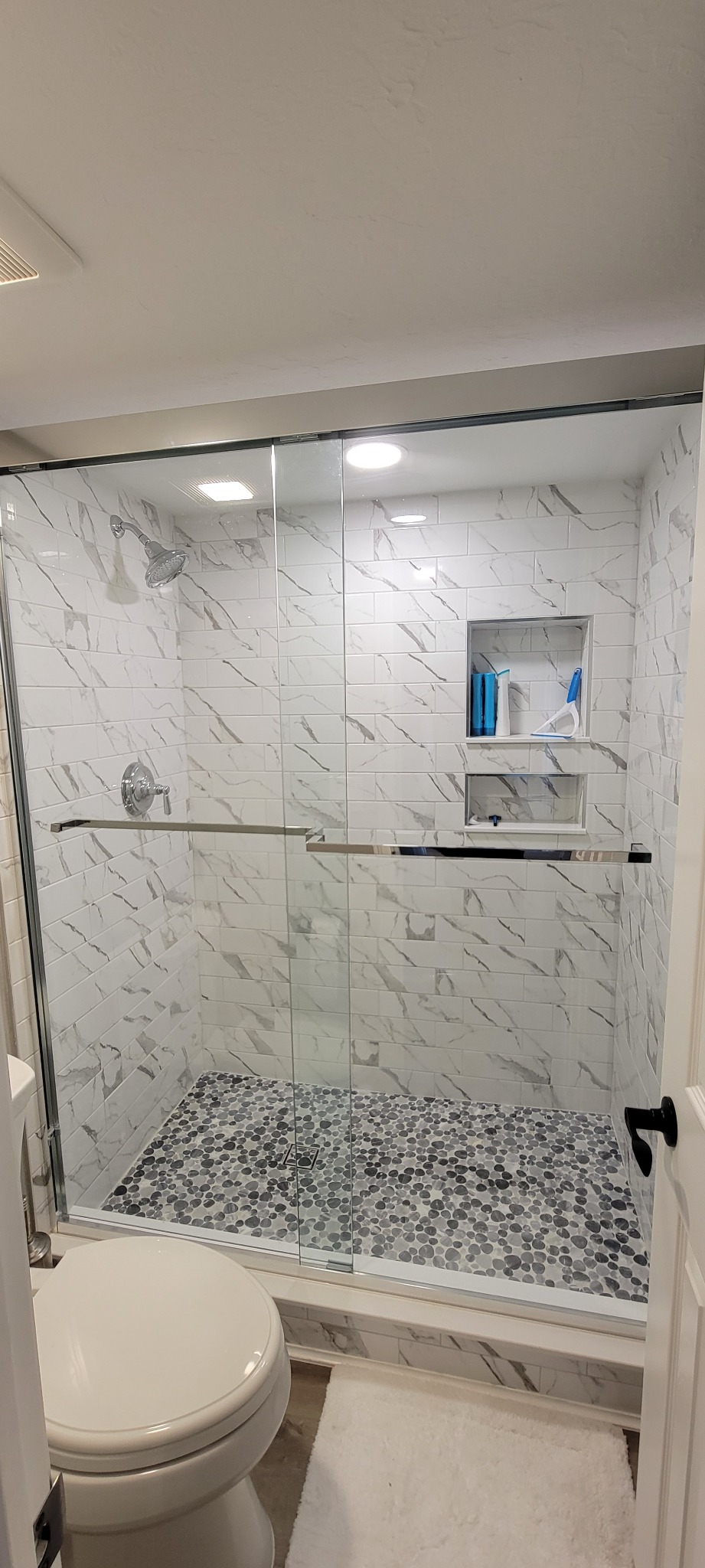 Completed glass-enclosed tiled shower