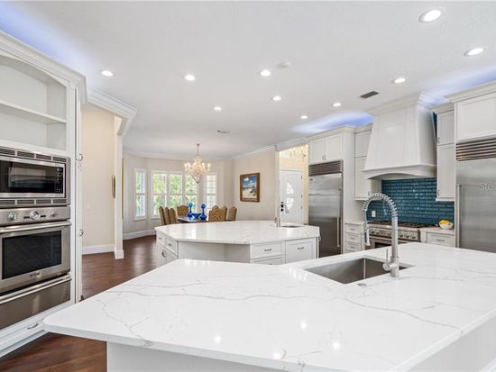 Completed kitchen showing large work surface, sink and appliance wall