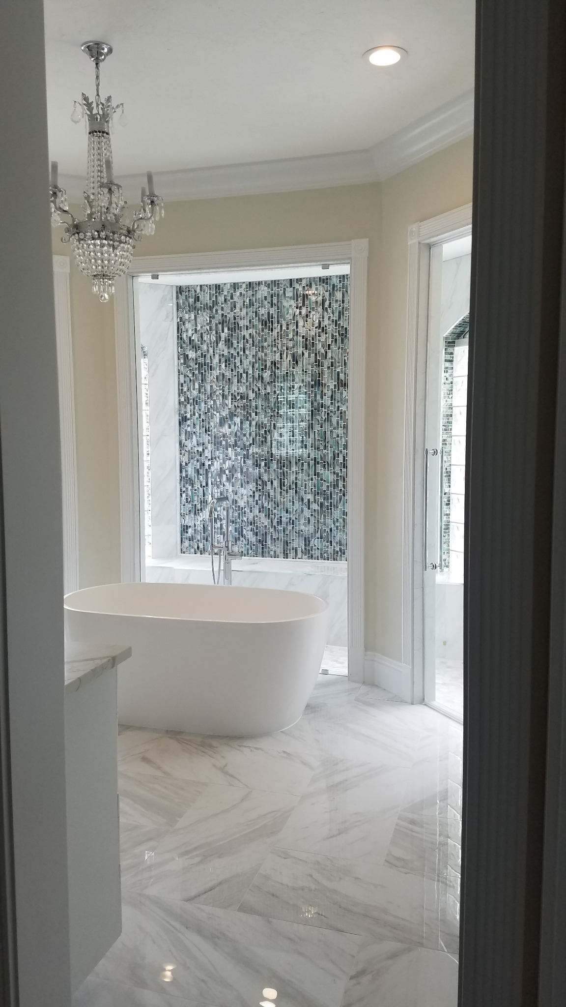 Primary bathroom after renovation with freestanding tub