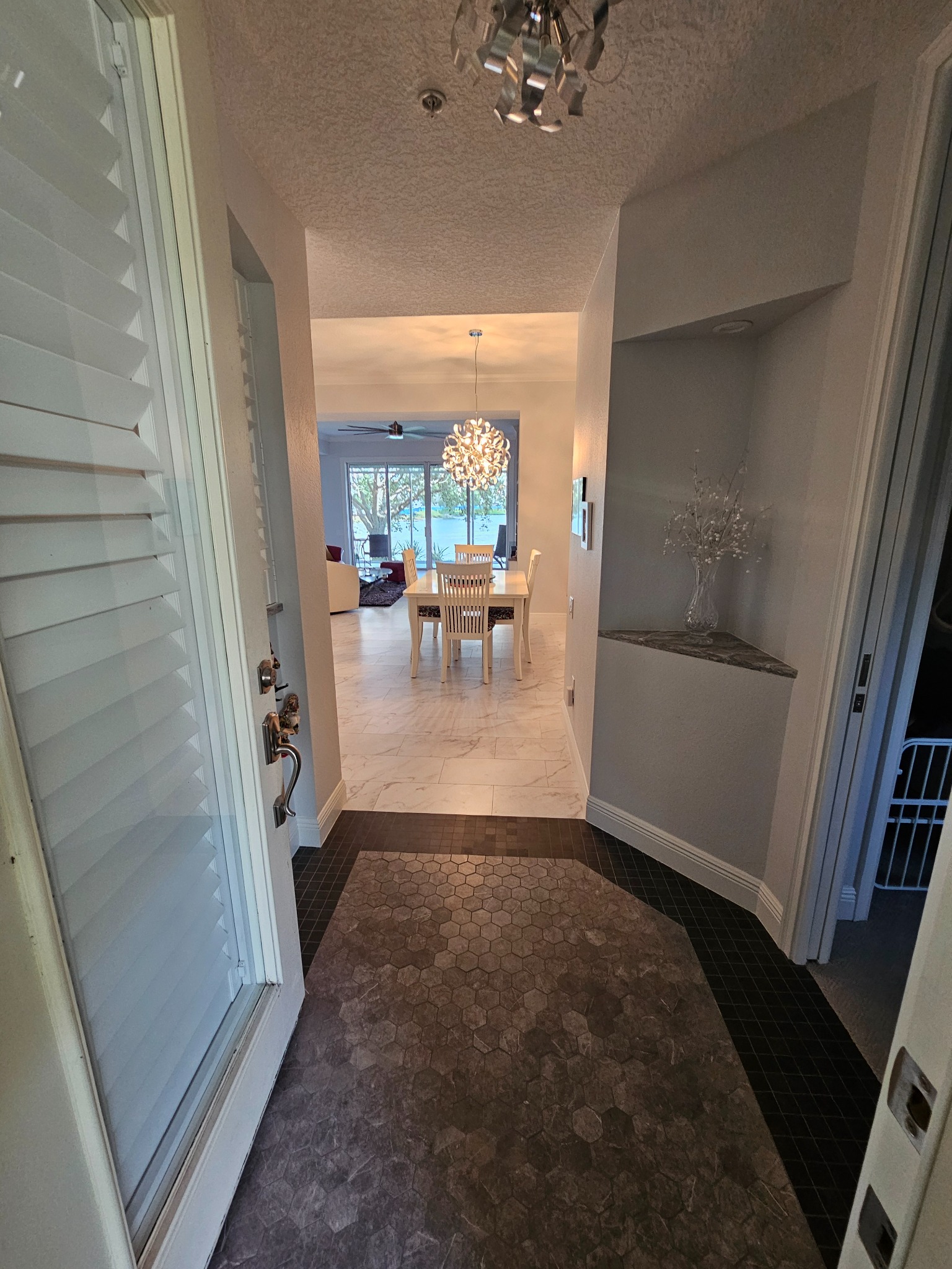 Completed custom kitchen with gray cabinetry and sculpted stone island