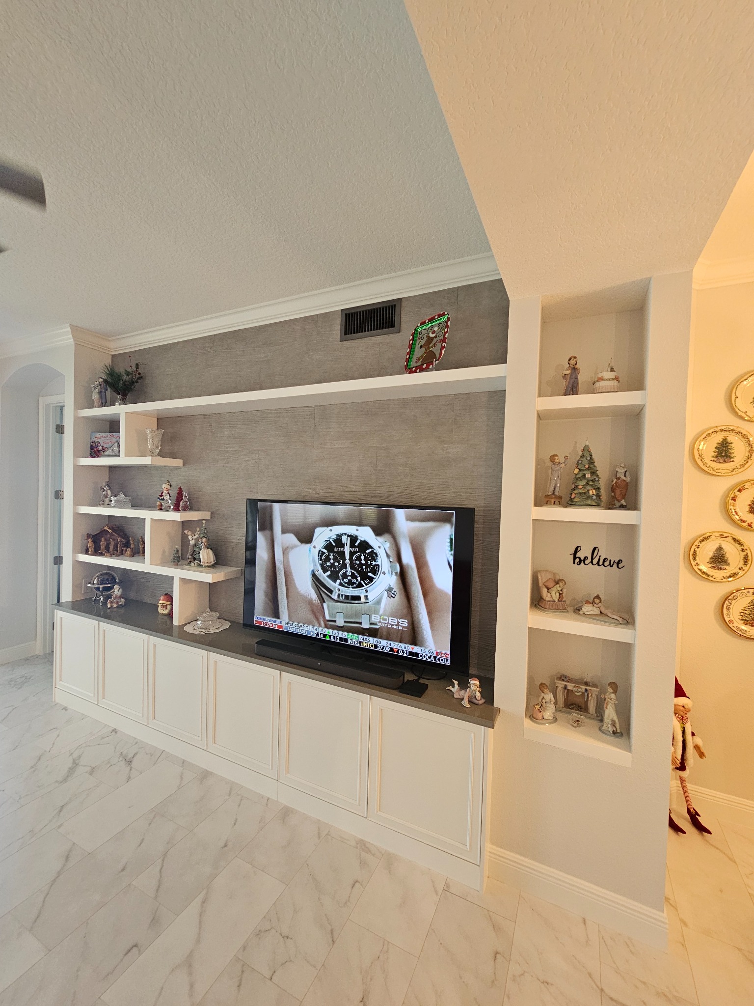 Completed primary bathroom double vanity with custom cabinetry and mosaic accents