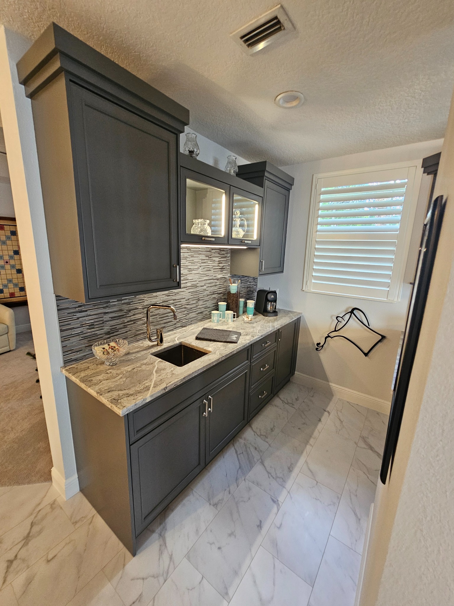 Completed walk-in shower with frameless glass and pebble mosaic floor